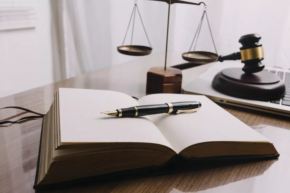 business-lawyers-discussing-contract-papers-with-brass-scale-desk-office-law-legal-services-advice-justice-law-concept-picture-with-film-grain-effect