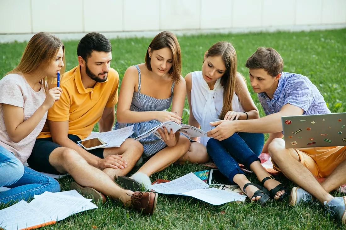 group-studying-students-sitting-grass-with-note-books