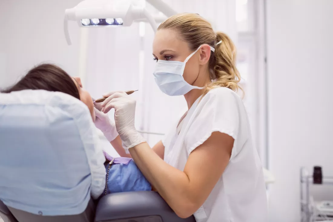 dentist-examining-female-patient